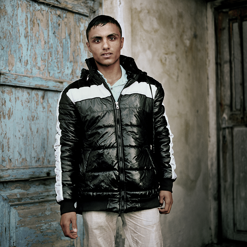 Mohammed in drenched clothes, poses for a portrait after disembarking on Lesvos island. He fled the war in Syria and says he will continue towards Germany where he hopes to find a good life and treatment for his diabetes. esvos, Greece. October 2015